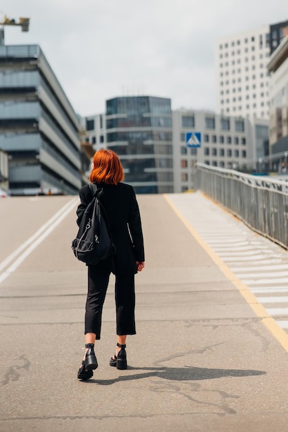 Jonge vrouw met een rugzak op de weg