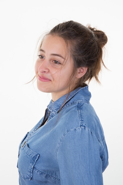 Jonge vrouw met haar in een broodje met denimoverhemd