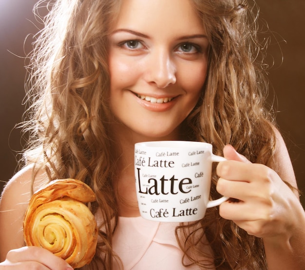 Foto jonge vrouw met koffie en cake