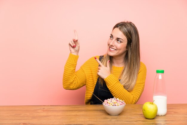 Jonge vrouw met kom van granen wijzen met de wijsvinger een geweldig idee