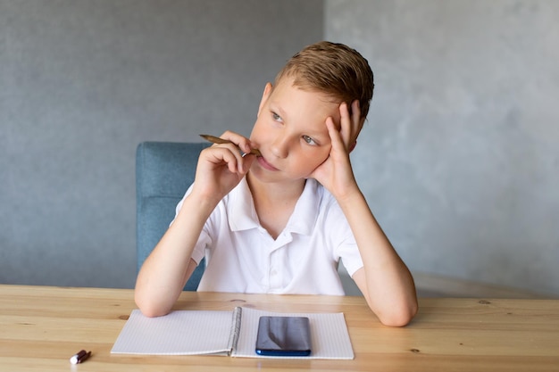 Foto jonge vrouw met mobiele telefoon terwijl ze op tafel zit