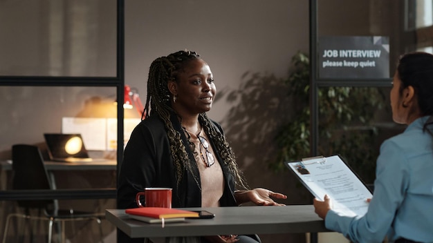 Jonge vrouw met sollicitatiegesprek op kantoor