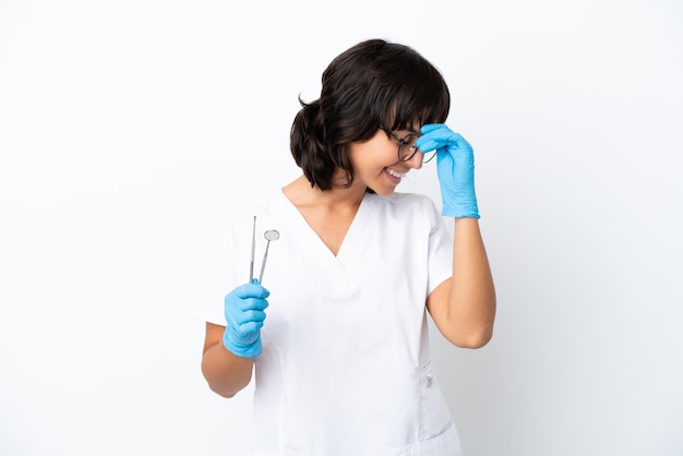 Jonge vrouw met tools geïsoleerd op een witte achtergrond lachen