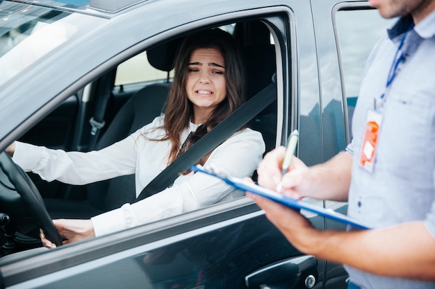 Jonge vrouw op haar rijbewijsexamen