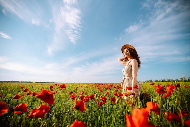 Jonge vrouw wandelen in een geweldig papaverveld Natuurvakantie ontspannen en levensstijl