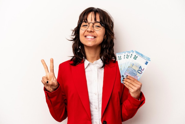 Jonge zaken Spaanse vrouw met bankbiljetten geïsoleerd op een witte achtergrond met nummer twee met vingers