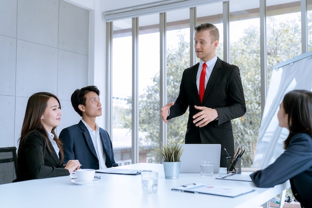 Jonge zakenlui worden marketingwerkproject gepresenteerd aan de klant in het kantoor van de vergaderzaal