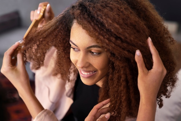 Foto jonge zwarte persoon die voor afrohaar zorgt