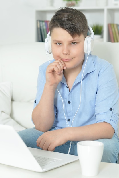 jongen die thuis een laptop gebruikt