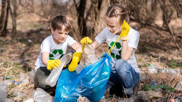 Jongen en meisje bij het ophalen van plastic afval