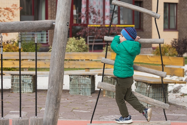 jongen klimt een touwladder in park