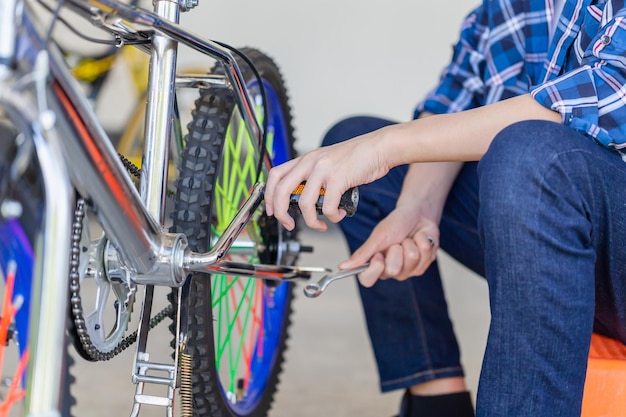 Jongen tot vaststelling van fiets, mechanische hobby en reparatie concepten.