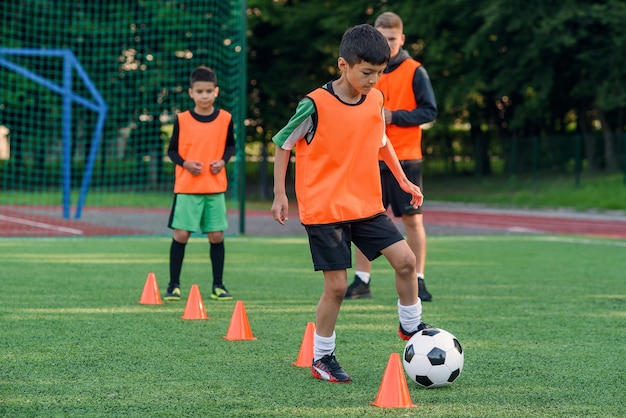 Jongen training op een voetbalveld