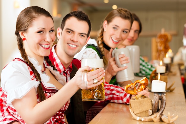 Jongeren in traditionele Beierse klederdracht in restaurant of pub