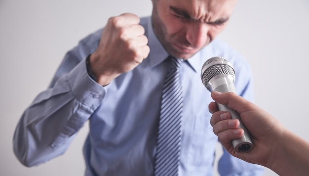 Journalist with microphone making interview.