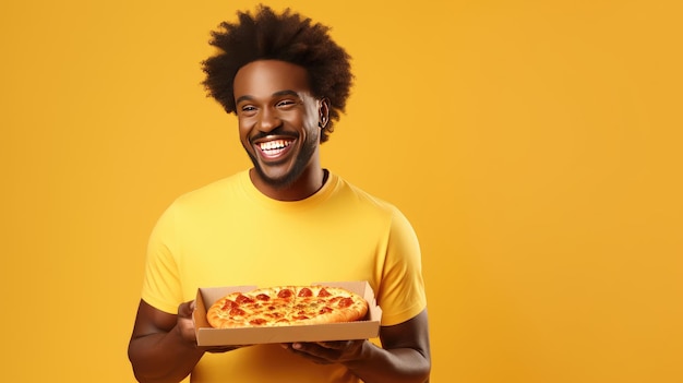 joy of a cheerful African American man in Tshirt holding a box of pizza savoring the delicious smell on a vibrant yellow isolated background