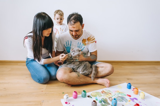 Joy family art happy father  mother and son show hands in bright colors paint together picture art