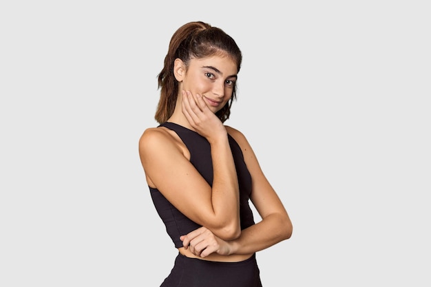 Joyful athletic Caucasian woman posing in studio