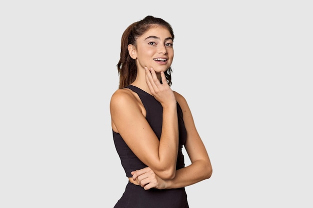 Joyful athletic Caucasian woman posing in studio