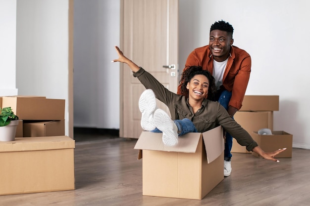 Joyful Black Spouses Having Fun Celebrating Moving New Apartment