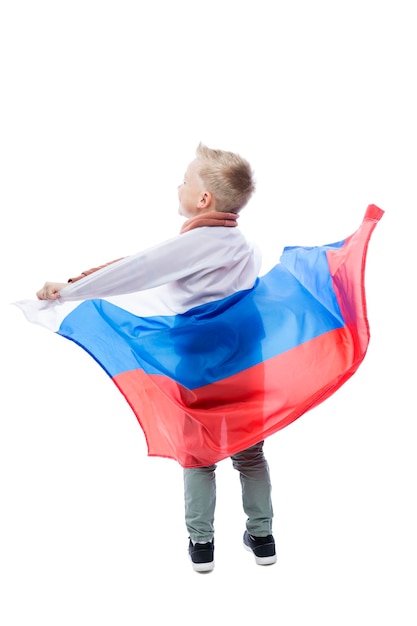 Joyful boy with a big Russian flag Positivity and celebration of Independence Day full height Isolated on white background Vertical