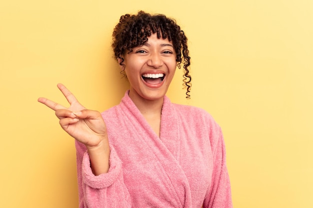 Joyful and carefree showing a peace symbol with fingers