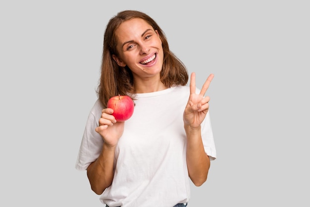 Joyful and carefree showing a peace symbol with fingers