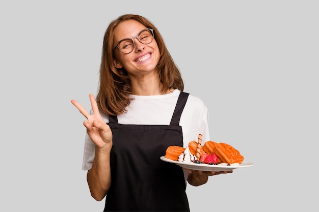 Joyful and carefree showing a peace symbol with fingers