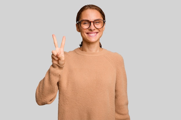 Joyful and carefree showing a peace symbol with fingers