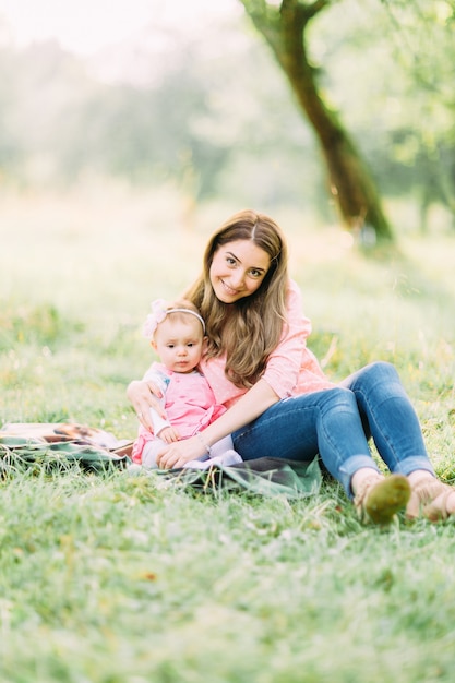 Joyful child in pink dress and her mother