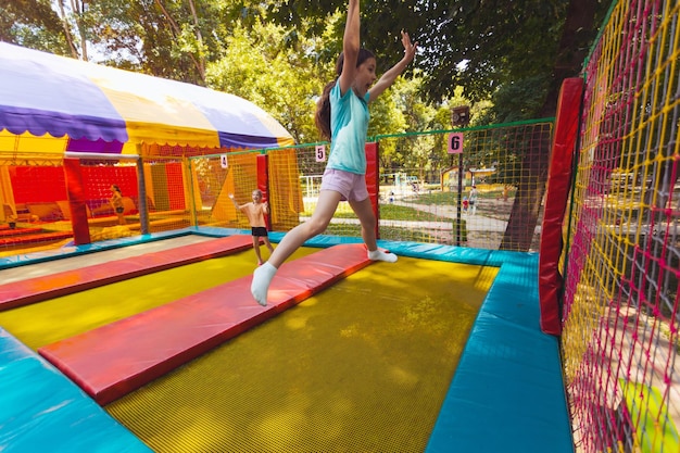 The joyful children are jumping in the trampoline park