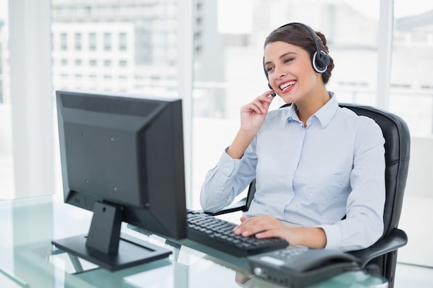 Joyful classy brown haired operator answering a call