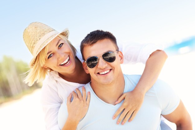 joyful couple having fun at the beach