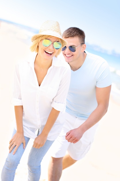 joyful couple having fun at the beach