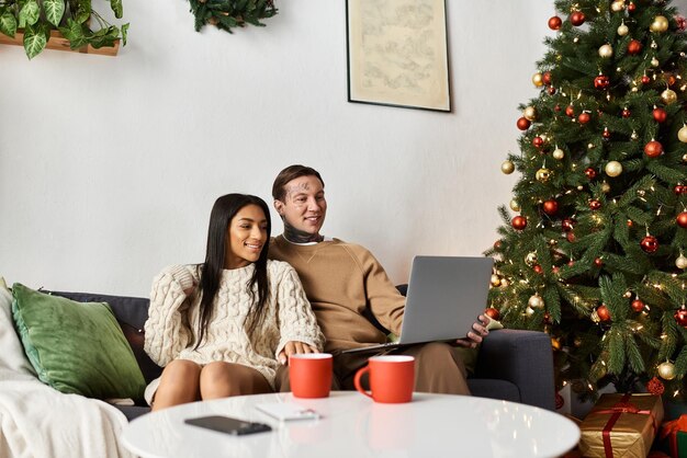 A joyful couple sharing a cozy moment at home surrounded by holiday decorations during Christmas