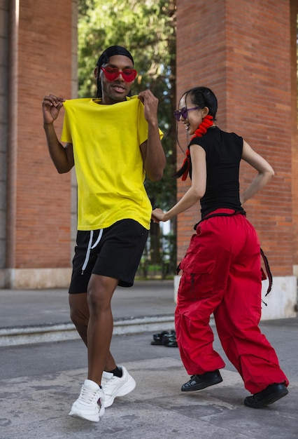 Joyful dance partners in colorful streetwear