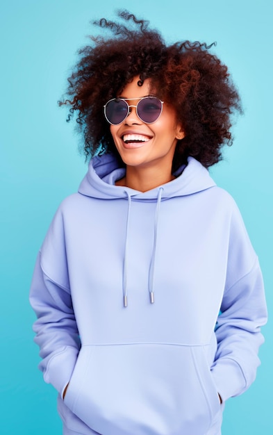 Joyful dark skinned woman with sunglasses over blue background Positive emotions and feelings