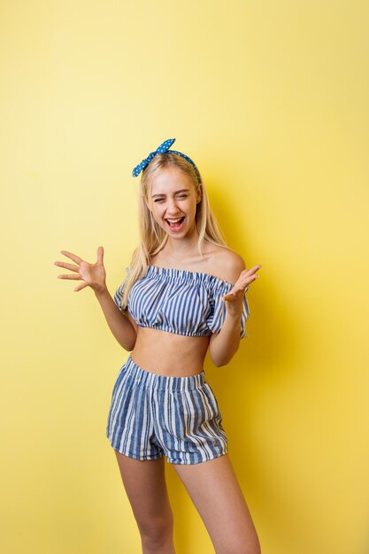 Joyful and excited beautiful blonde girl in summer outfit