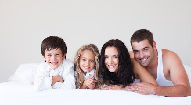 Joyful family lying on their bed