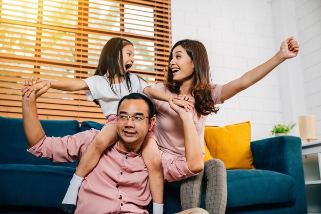 A joyful family in their comfortable modern house enjoys quality time on the sofa