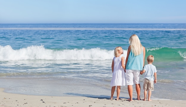 Joyful family walking on the beach