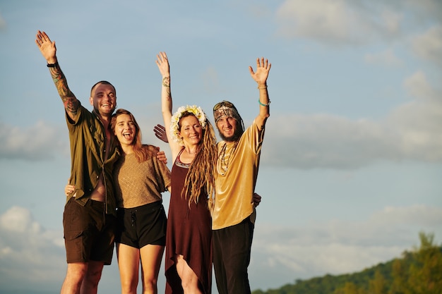 Joyful friends in sunset sun rays