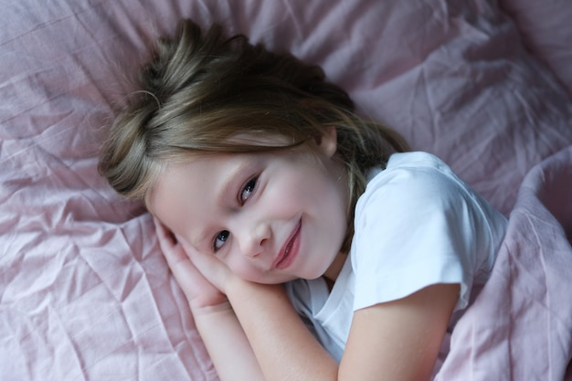 Joyful girl getting ready to sleep, close-up