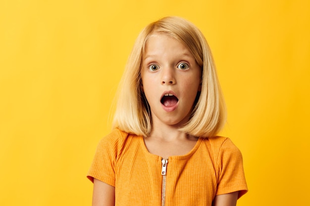 Joyful girl with blond hair gesturing with her hands