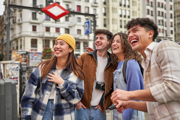 A joyful group of friends from different cultures having a great time exploring Madrid on vacation