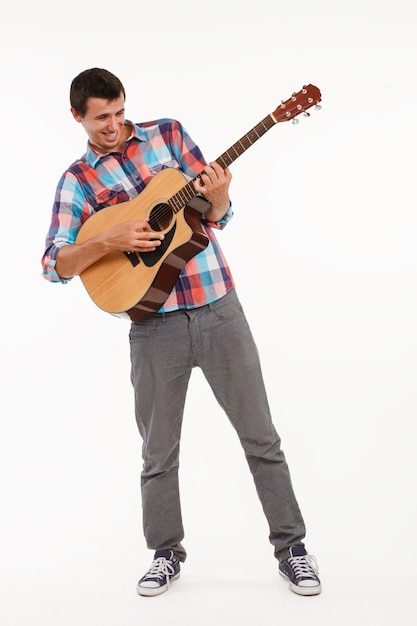 Joyful guy playing guitar.