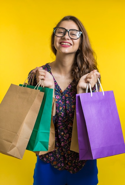 Joyful Indian girl holding shopping bags