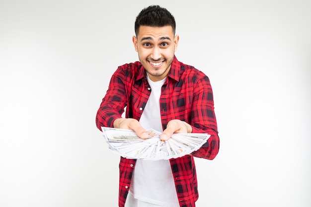 Joyful man boasting a prize holding out money on a white background