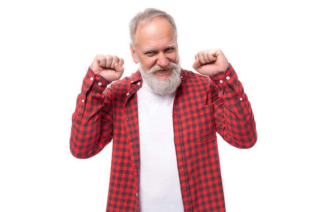 Joyful mature grayhaired man with a beard won a prize