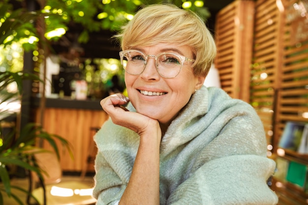 Joyful mature woman in eyeglasses